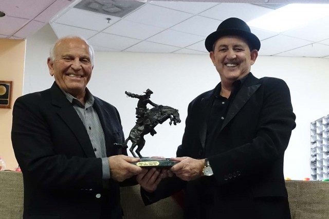 Amnon presenting Enzo with Frederick Remington's "The Broncho Buster"