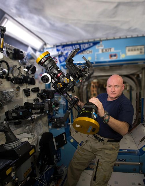 ISS043E276473 - NASA astronaut Scott Kelly preparing IMAX camera equipment & C500 weightless_03 - blurred